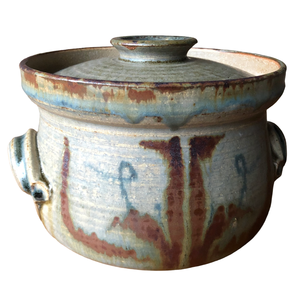 Vera Tollow stoneware casserole with fitted lid, blue-grey and olive glaze, rust-red brushwork and two side handles, on white background