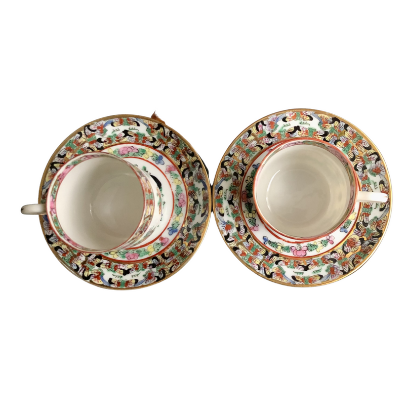 pair of fabulous vintage Famille Rose hand-decorated eggshell porcelain coffee cups and saucers. Japanese porcelain decorated in Hong Kong with auspicious symbols including butterflies, roses and peaches in the 20th century back stamp YT