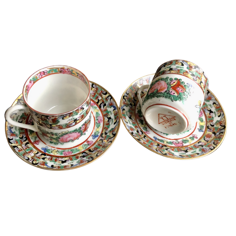 pair of fabulous vintage Famille Rose hand-decorated eggshell porcelain coffee cups and saucers. Japanese porcelain decorated in Hong Kong with auspicious symbols including butterflies, roses and peaches in the 20th century back stamp YT
