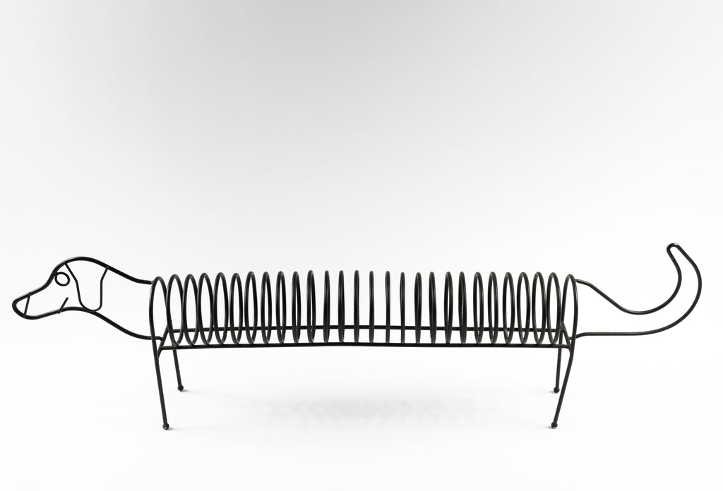 A black metal sausage dog CD holder/ record rack