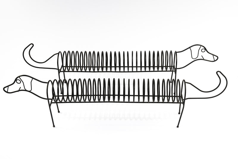 A black metal sausage dog CD holder/ record rack