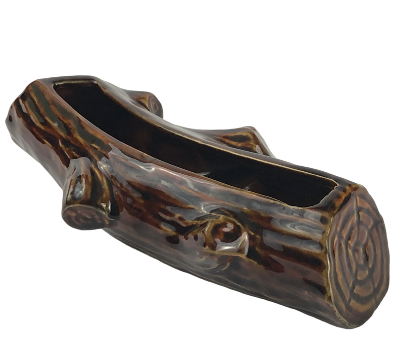 Angled view of Dartmouth Pottery log planter showing moulded branch stubs, growth rings and elongated planting opening.