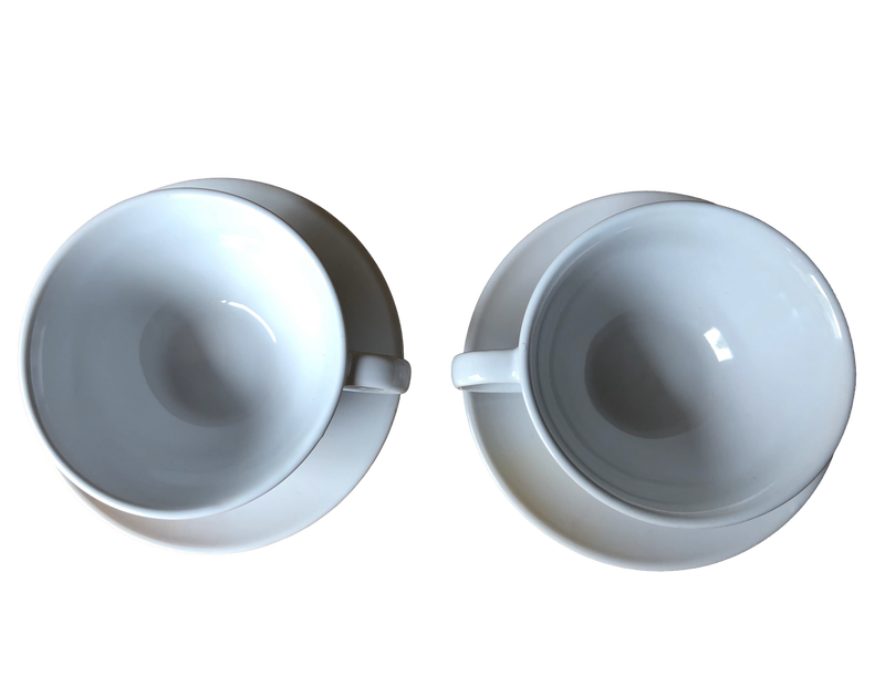 Photo looking down into the two cups: Plain white interiors of the two vintage Nescafé promotional coffee cups, seen from above