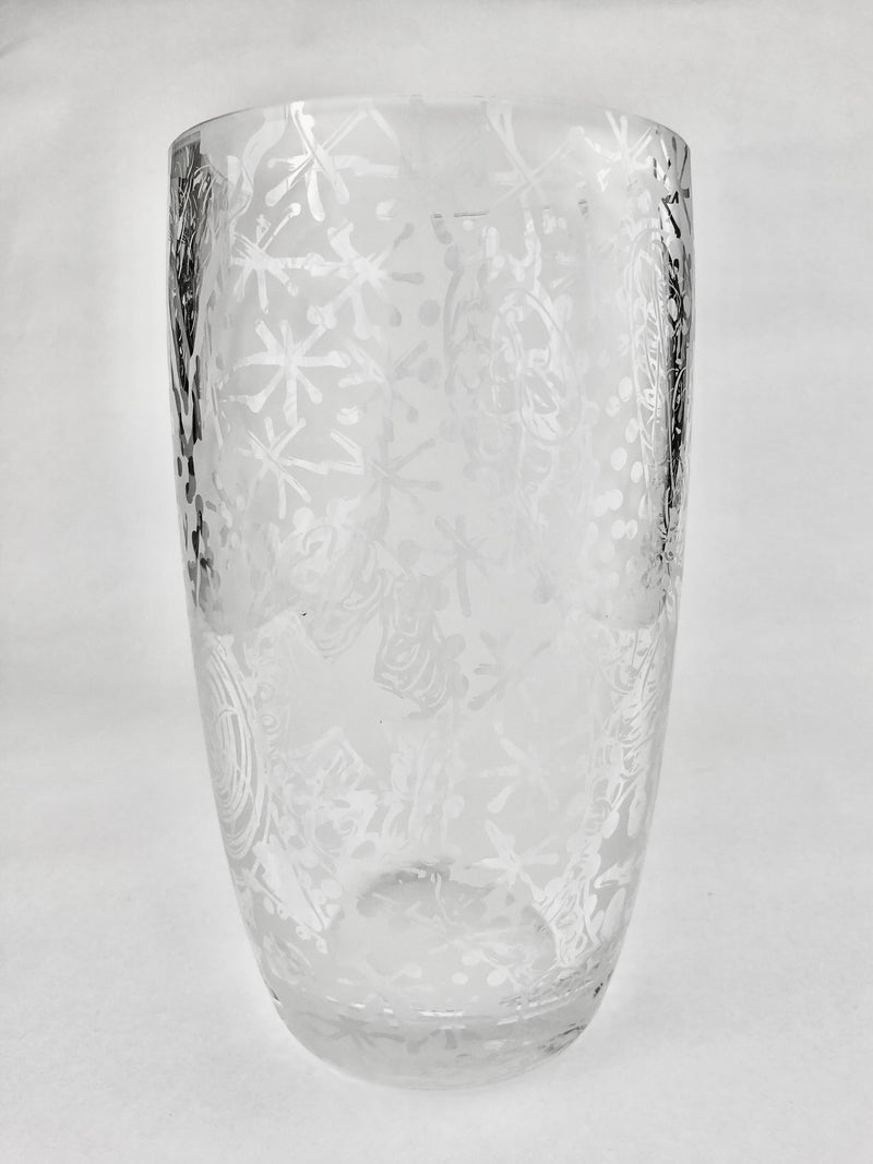 Clear crystal vase with freehand etched spirals, dots and sweeping abstract lines, tapering towards a thick rounded base.