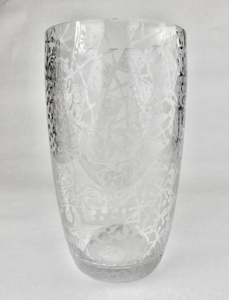 Clear crystal vase with freehand etched spirals, dots and sweeping abstract lines, tapering towards a thick rounded base.