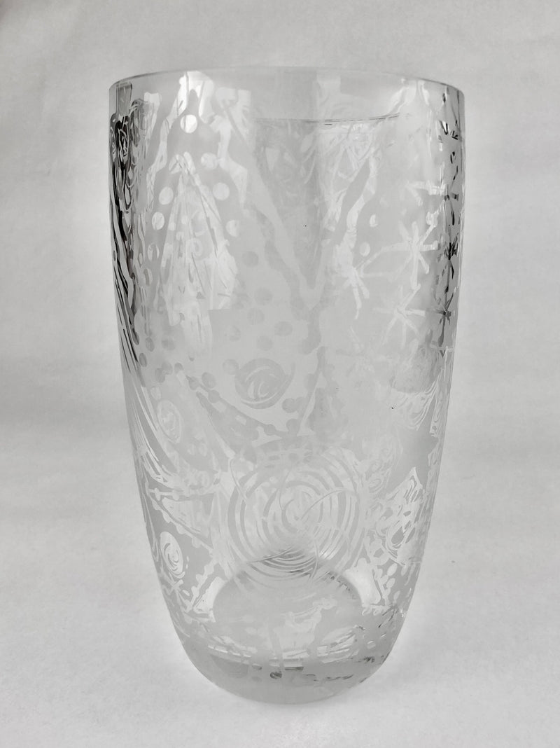 Clear crystal vase with freehand etched spirals, dots and sweeping abstract lines, tapering towards a thick rounded base.