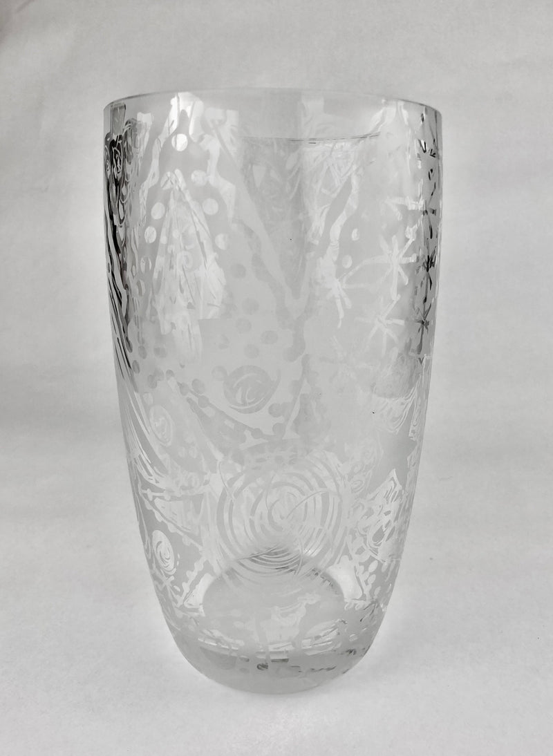 Clear crystal vase with freehand etched spirals, dots and sweeping abstract lines, tapering towards a thick rounded base.
