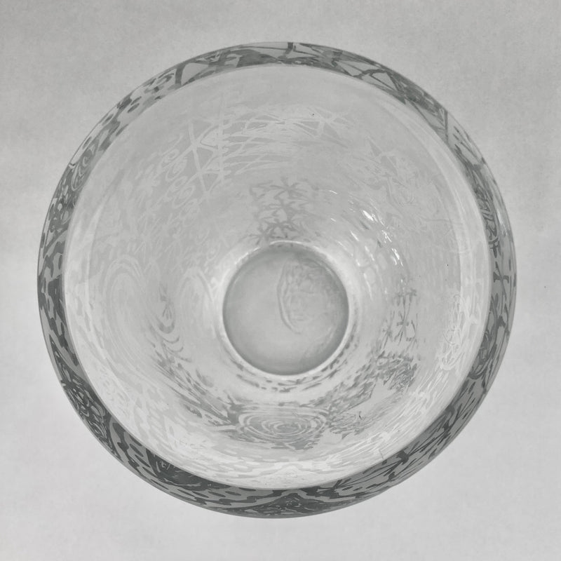 Top view of the crystal vase showing its circular opening, thick rim and abstract etched decoration.