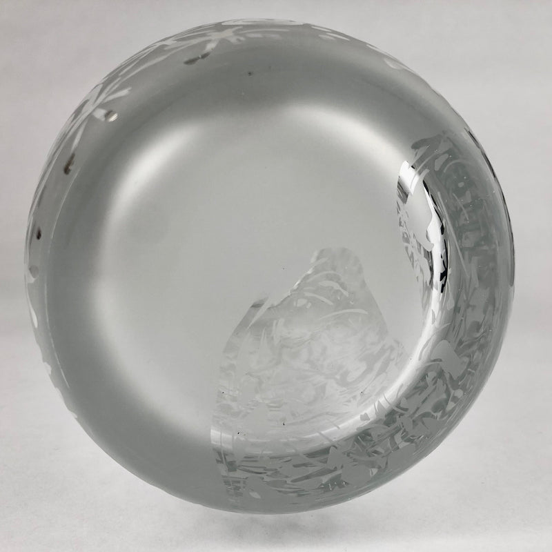 Underside of the clear crystal vase showing its circular glass base.