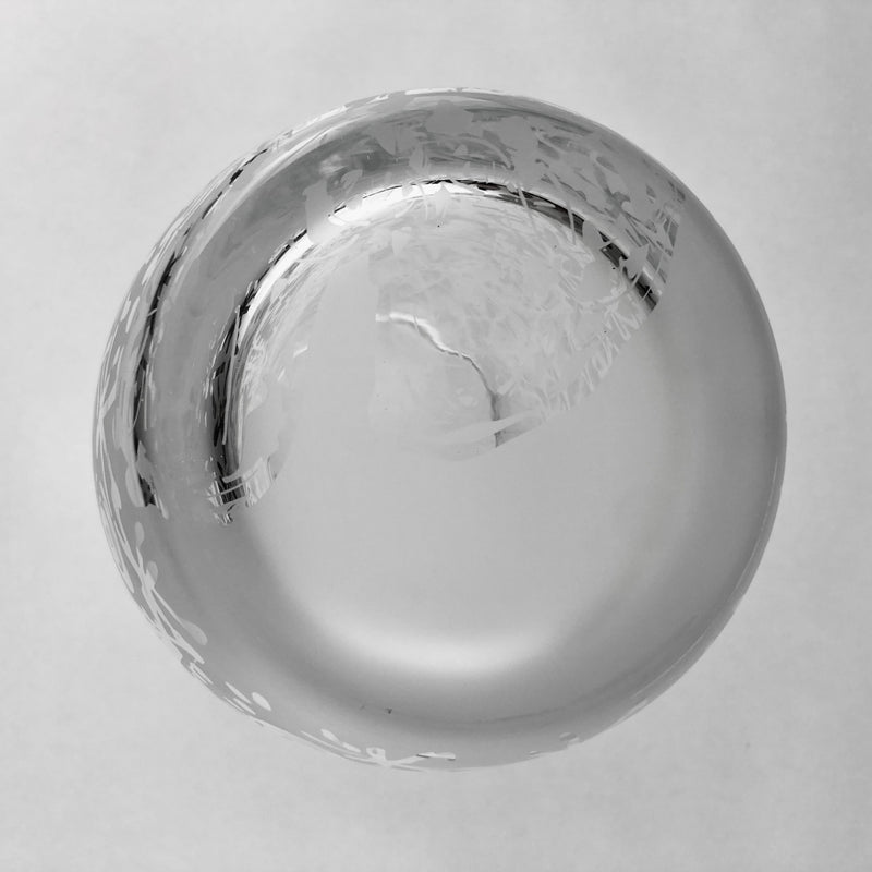 Underside of the clear crystal vase showing its circular glass base.