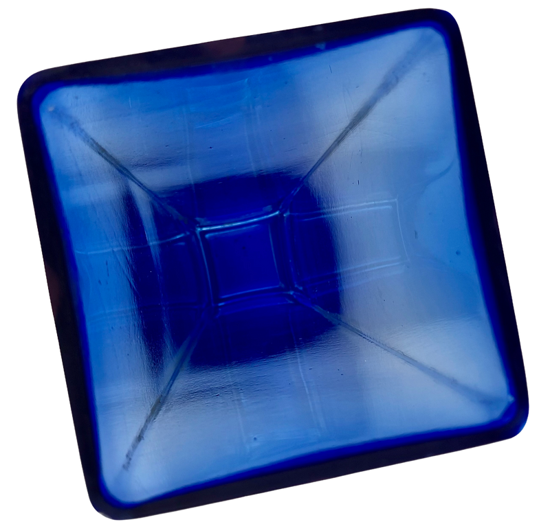 Angled close-up looking into the square mouth of a blue glass vase, showing its interior texture.
