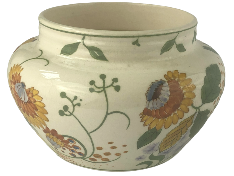 Side view of the Gouda cachepot showing ochre and rust-coloured chrysanthemums with curling green stems on a cream ground.