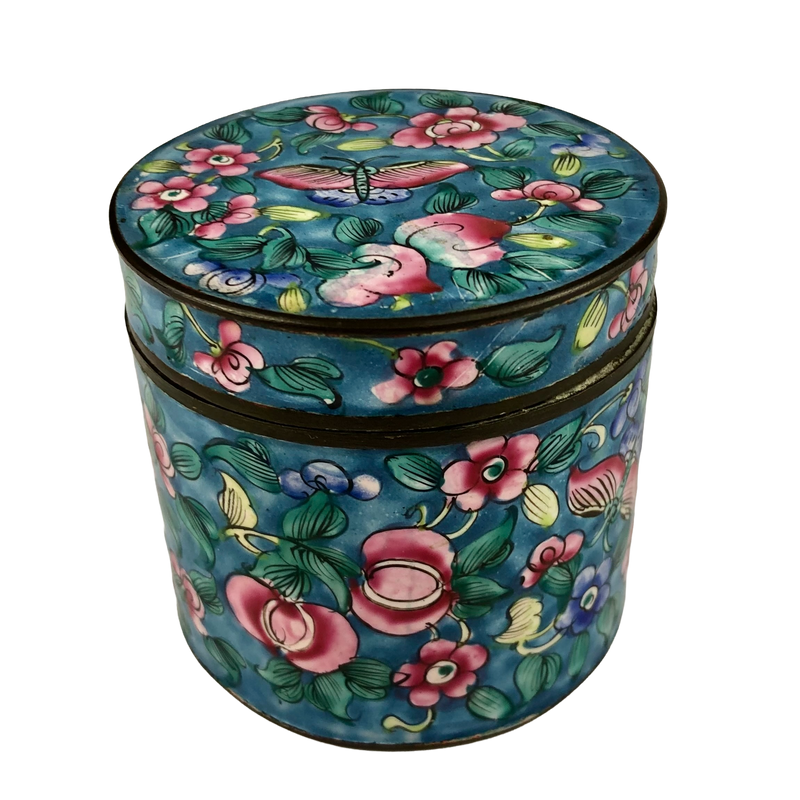 Side view of Canton enamel covered jar with pink flowers and green foliage on turquoise, with a butterfly decorating the lid.
