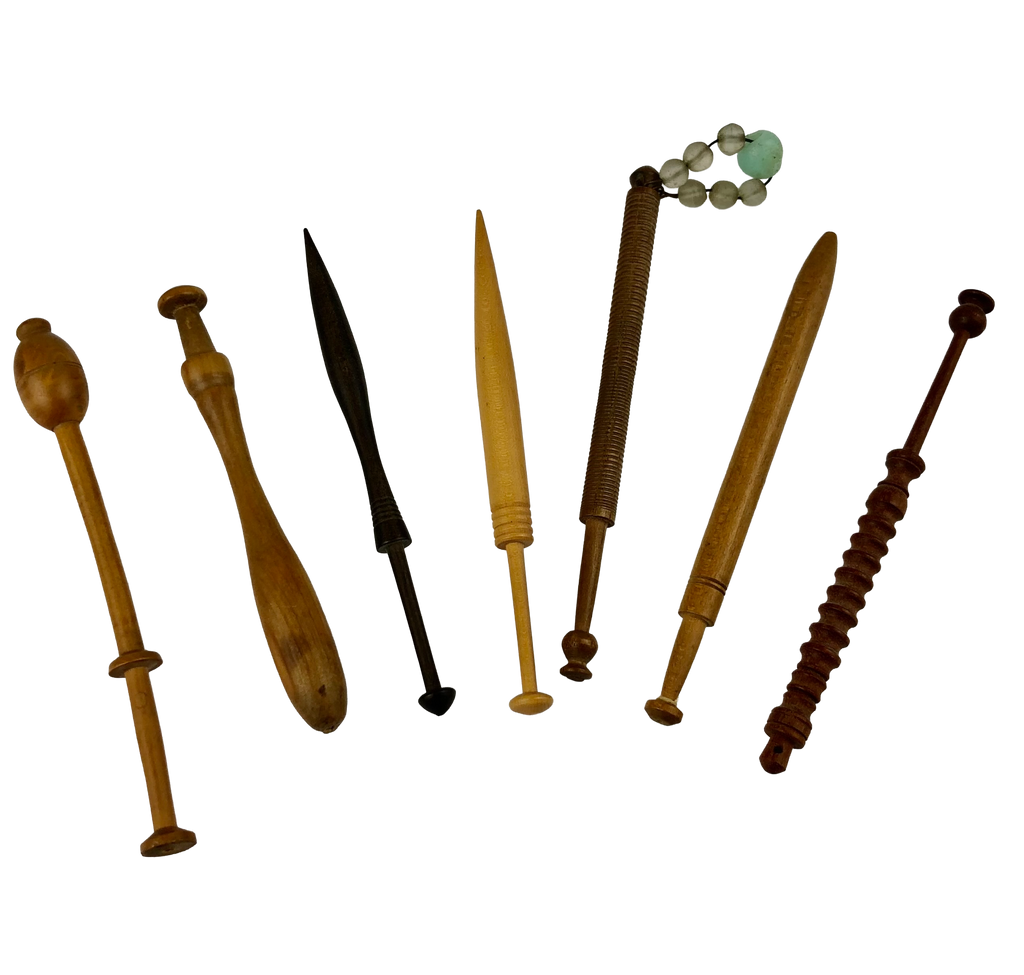 Seven antique English wooden lace bobbins in varied turned shapes, including one with a glass-bead spangle
