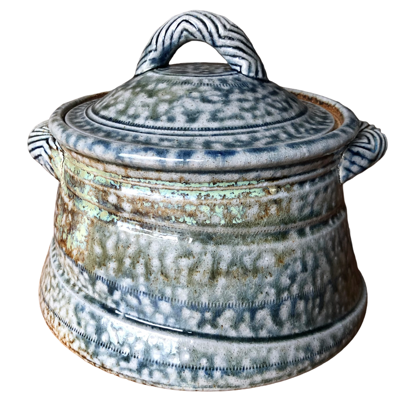 Jane Hamlyn salt-glazed stoneware casserole with mottled blue-grey glaze, fitted lid and chevron-patterned handles, on white background.