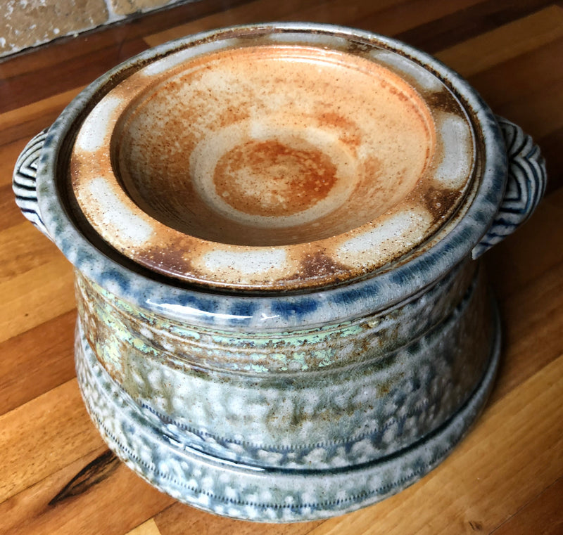 Jane Hamlyn stoneware casserole with the lid inverted on top, showing its cream and russet glazed underside