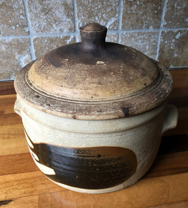 Alan Brough Newlyn Pottery casserole with fitted domed lid, small side handles and contrasting brown and buff surfaces.