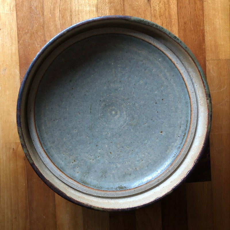 Underside of Vera Tollow stoneware casserole lid showing a blue-grey glazed surface and recessed fitting rim.