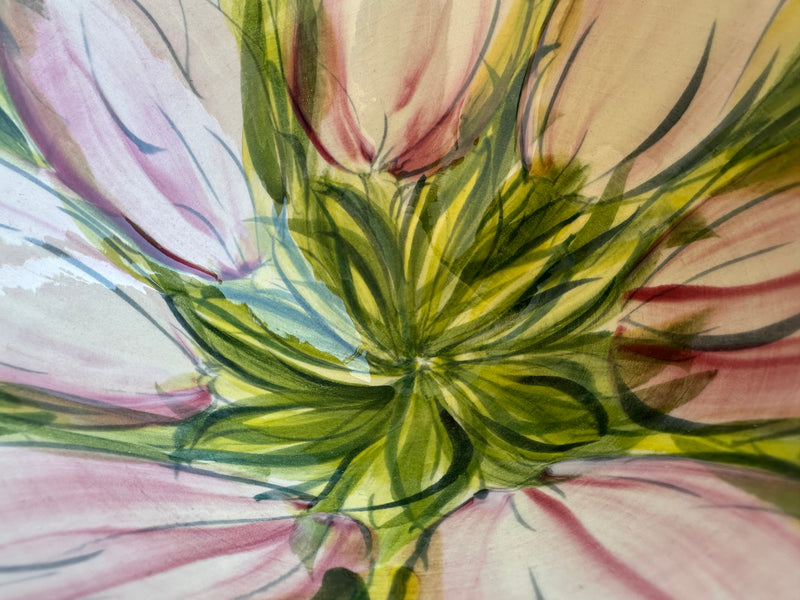 Close-up of freehand underglaze painting on Valerie Shelton ceramic bowl — green leaf cluster at centre surrounded by pink tulip petals