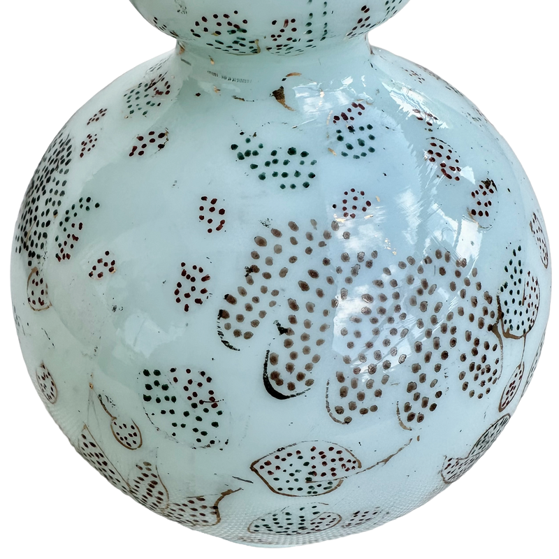 Close-up of dotted flowers, fine gilt outlines and wear to the decoration on the celadon opaline glass vase.