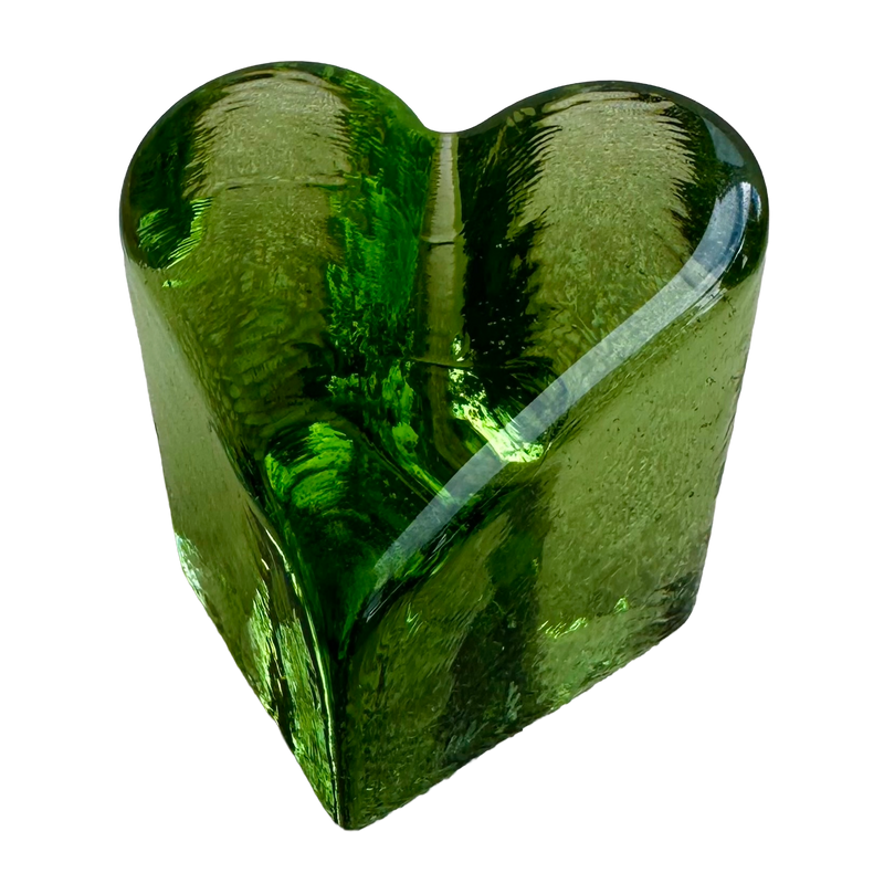 Fire & Light green glass heart paperweight, angled view showing rounded edges and rippled sides.