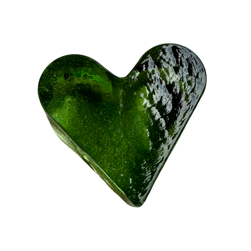 Overhead view of the base of Fire & Light green glass paperweight showing its full heart shape and tiny enclosed bubbles.