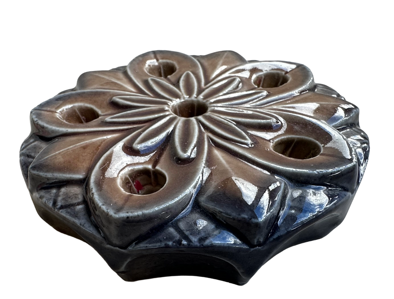 Angled view of the Wade Water Lily ceramic candle holder, showing its low profile and sculpted petal details.