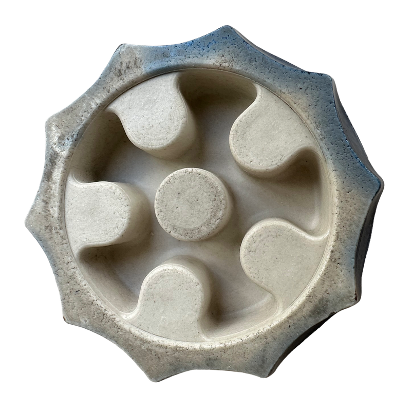 Underside: “Underside of the Wade Water Lily ceramic candle holder, showing the base and candle socket opening