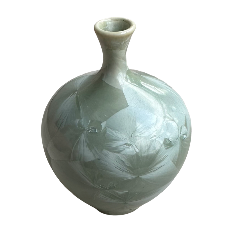 Full view of the Louise Reding porcelain bud vase with pale crystalline starbursts spreading across the sage-green glaze