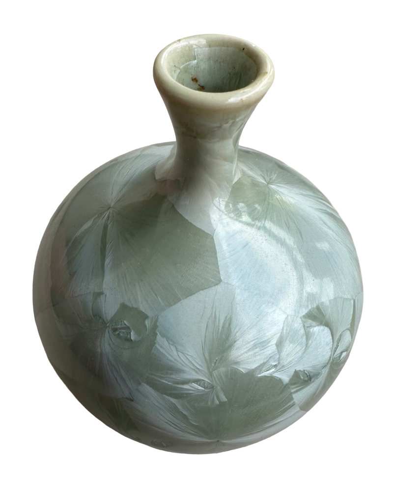 Elevated view of the Louise Reding crystalline glaze vase, showing its opening, slender neck and fan-shaped crystals.
