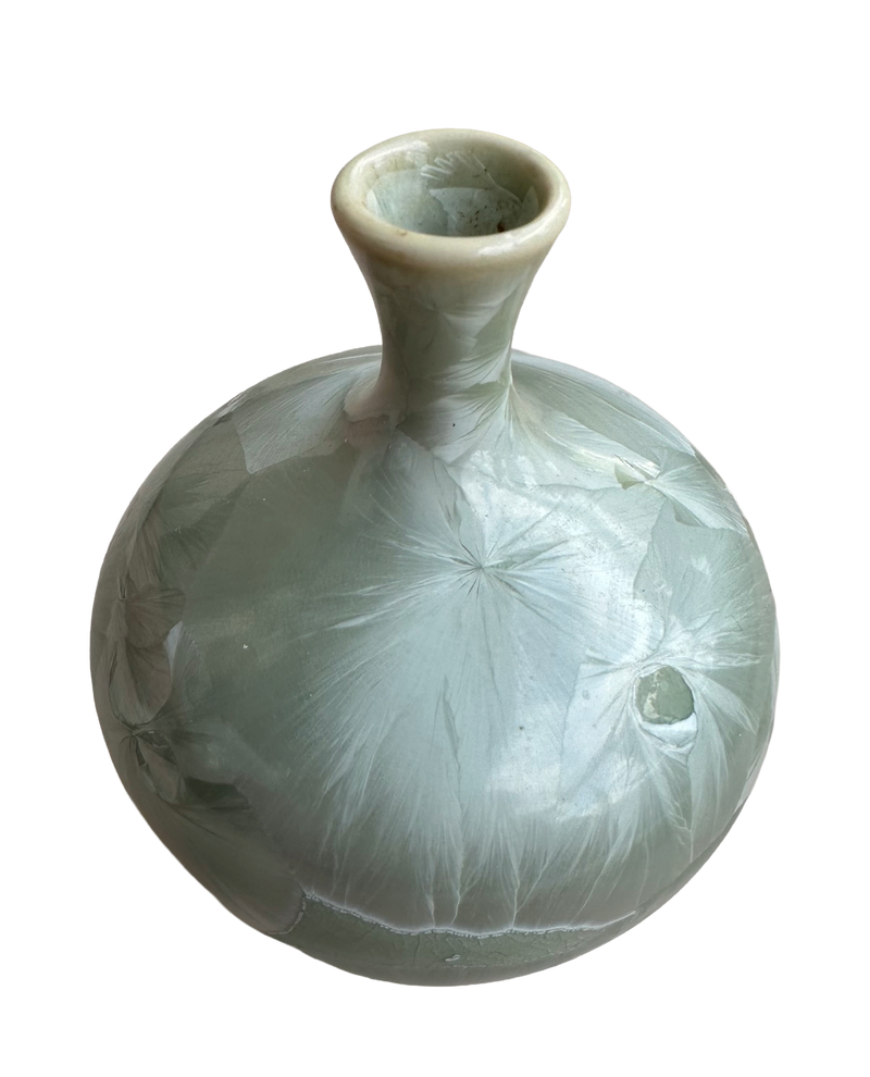 Louise Reding green porcelain bud vase viewed slightly from above, showing the flared rim and starburst crystal pattern