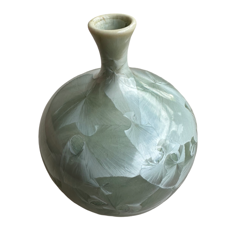Side view of the Louise Reding miniature bud vase, showing large pale crystal blooms across its rounded green body.
