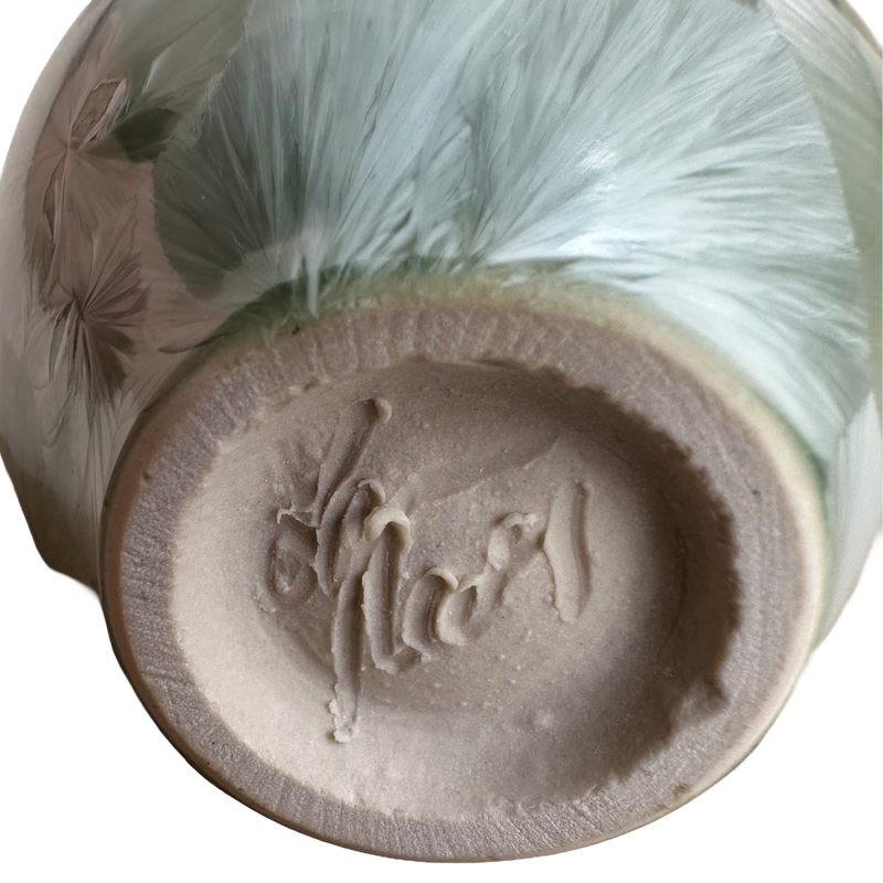 Close-up of the incised Reding signature on the unglazed base, with feathery green glaze crystals above the foot.
