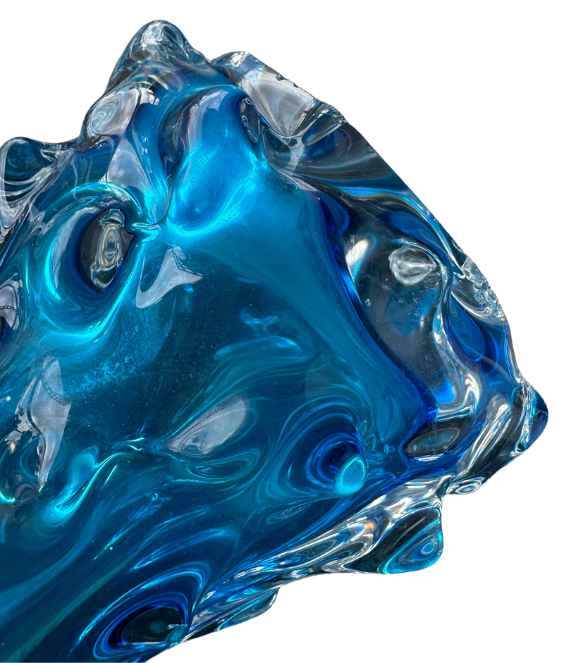Close-up of the turquoise vase’s lower body showing thick clear glass and sculpted thorn-shaped projections.
