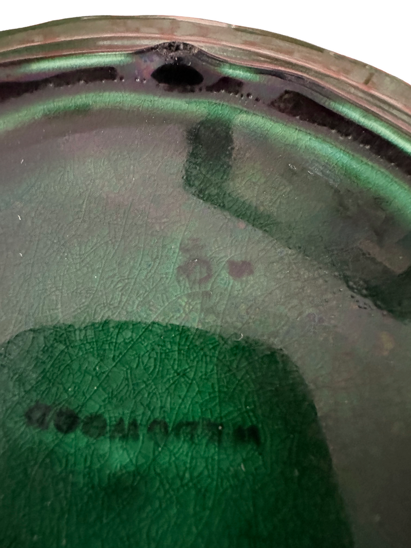 Close-up of translucent green majolica glaze on Victorian Wedgwood Sunflower plate showing pooled deep green tones, circa 1879

