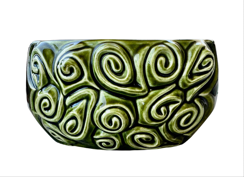 Close-up of embossed swirl and scroll relief pattern on 1970s SylvaC Harmony green glazed planter bowl