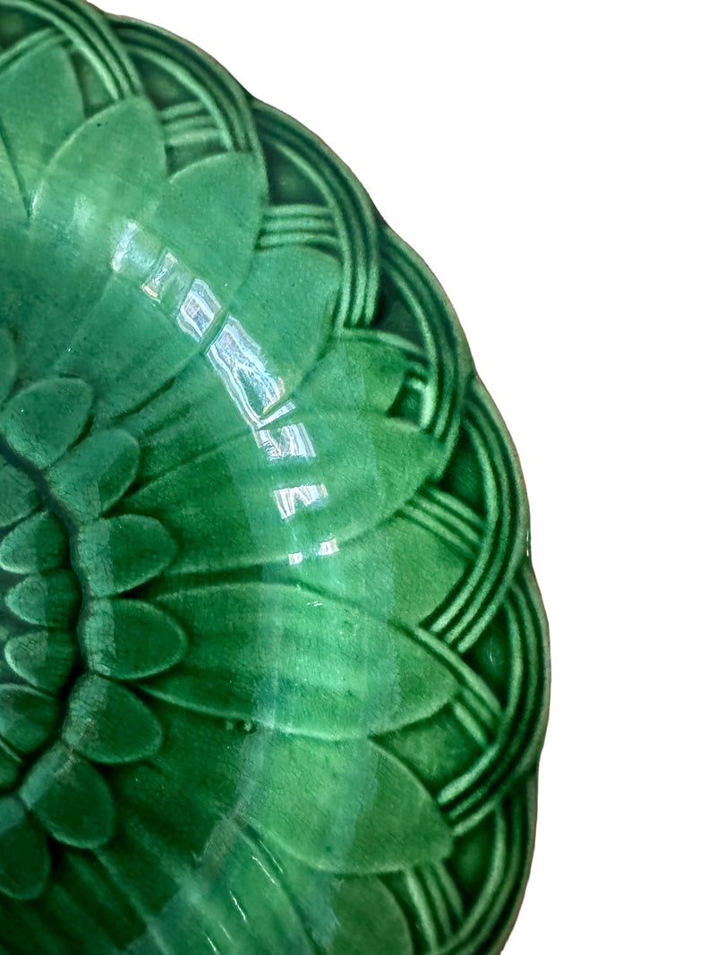 Close-up of translucent green majolica glaze on Victorian Wedgwood Sunflower plate showing pooled deep green tones, circa 1879
