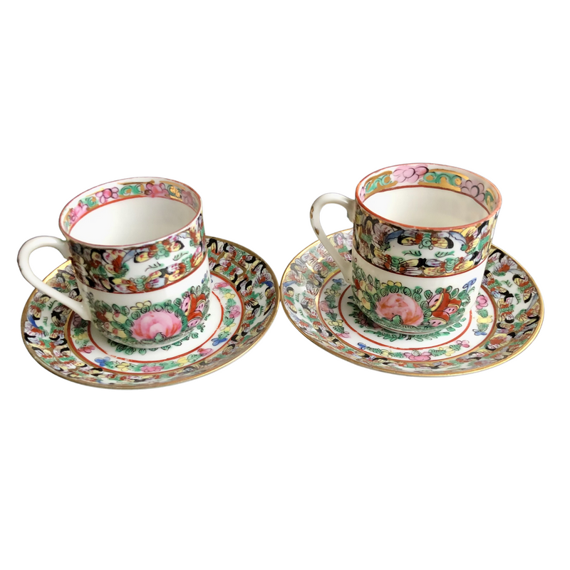 pair of fabulous vintage Famille Rose hand-decorated eggshell porcelain coffee cups and saucers. Japanese porcelain decorated in Hong Kong with auspicious symbols including butterflies, roses and peaches in the 20th century back stamp YT